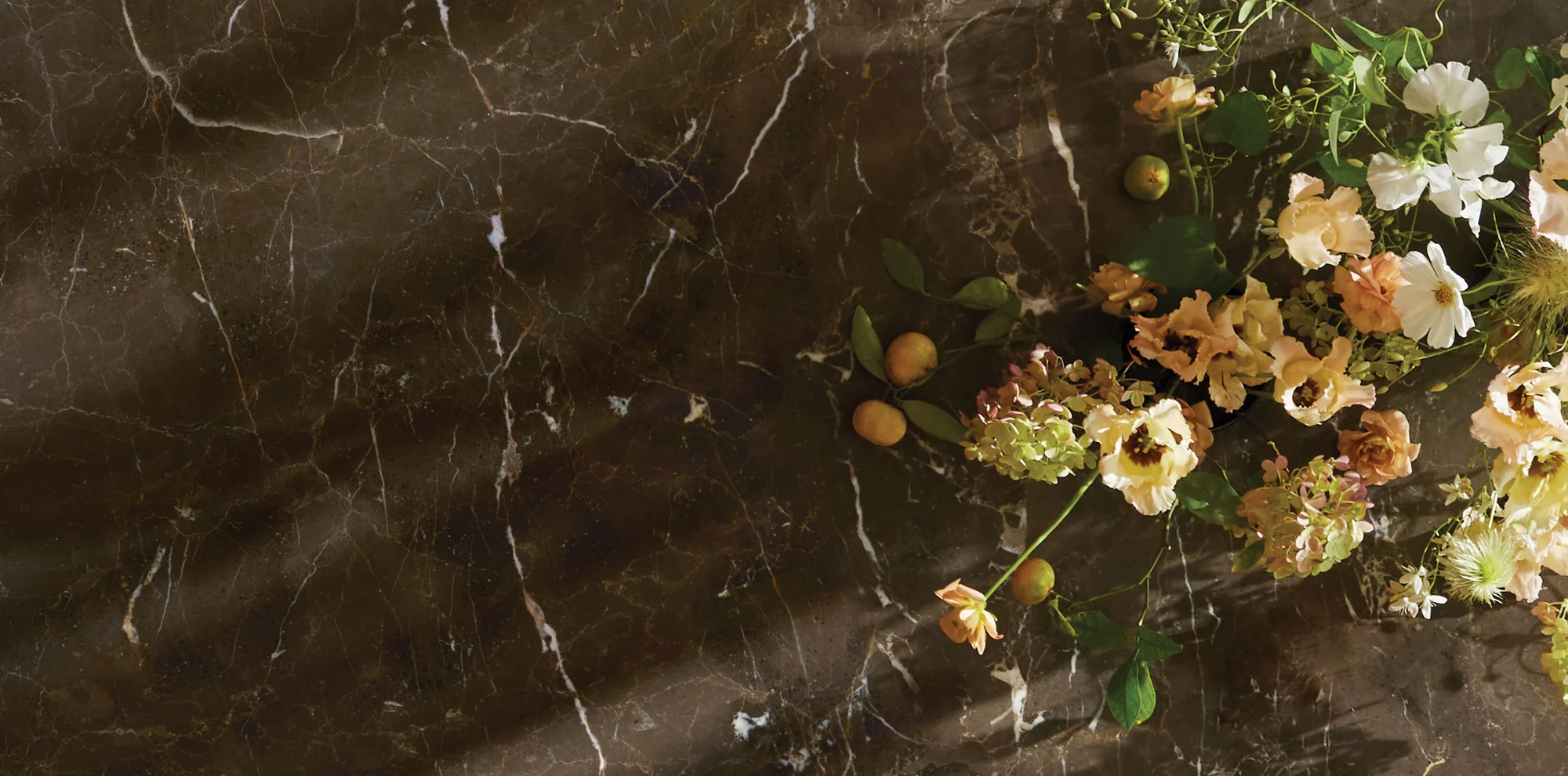 Stone texture of dining room table top with bright spring florals