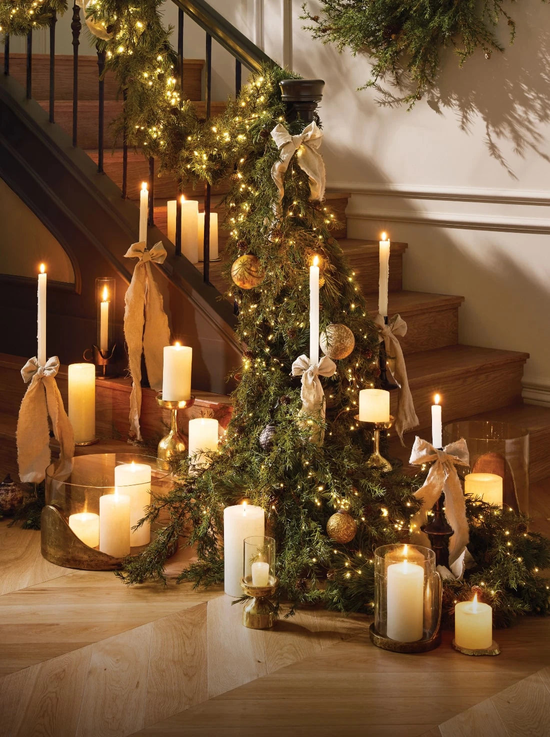 Holiday wreaths and garland adorned with candles 