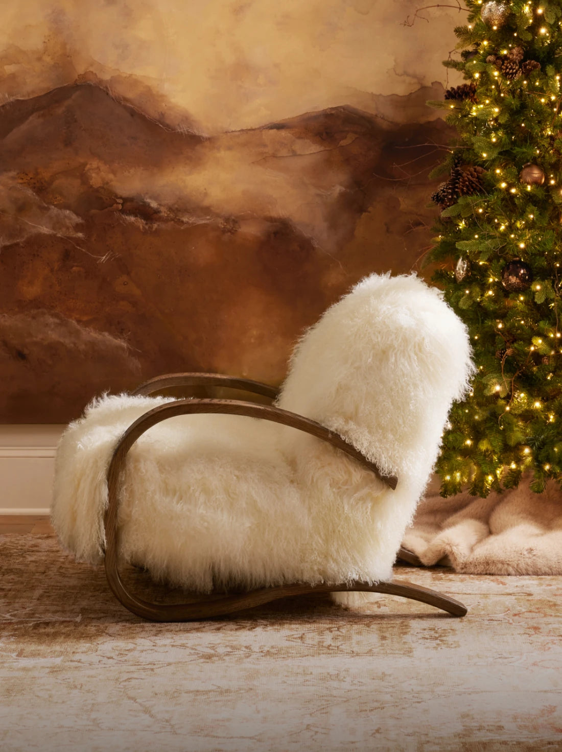 Fuzzy chair in front of a warm, glowing Christmas tree