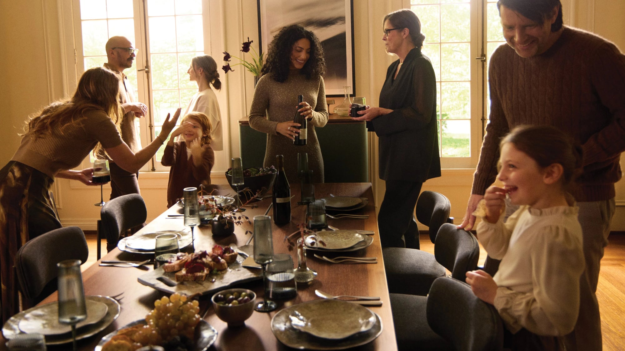 Group of friends enjoying a party around a dining room table.
