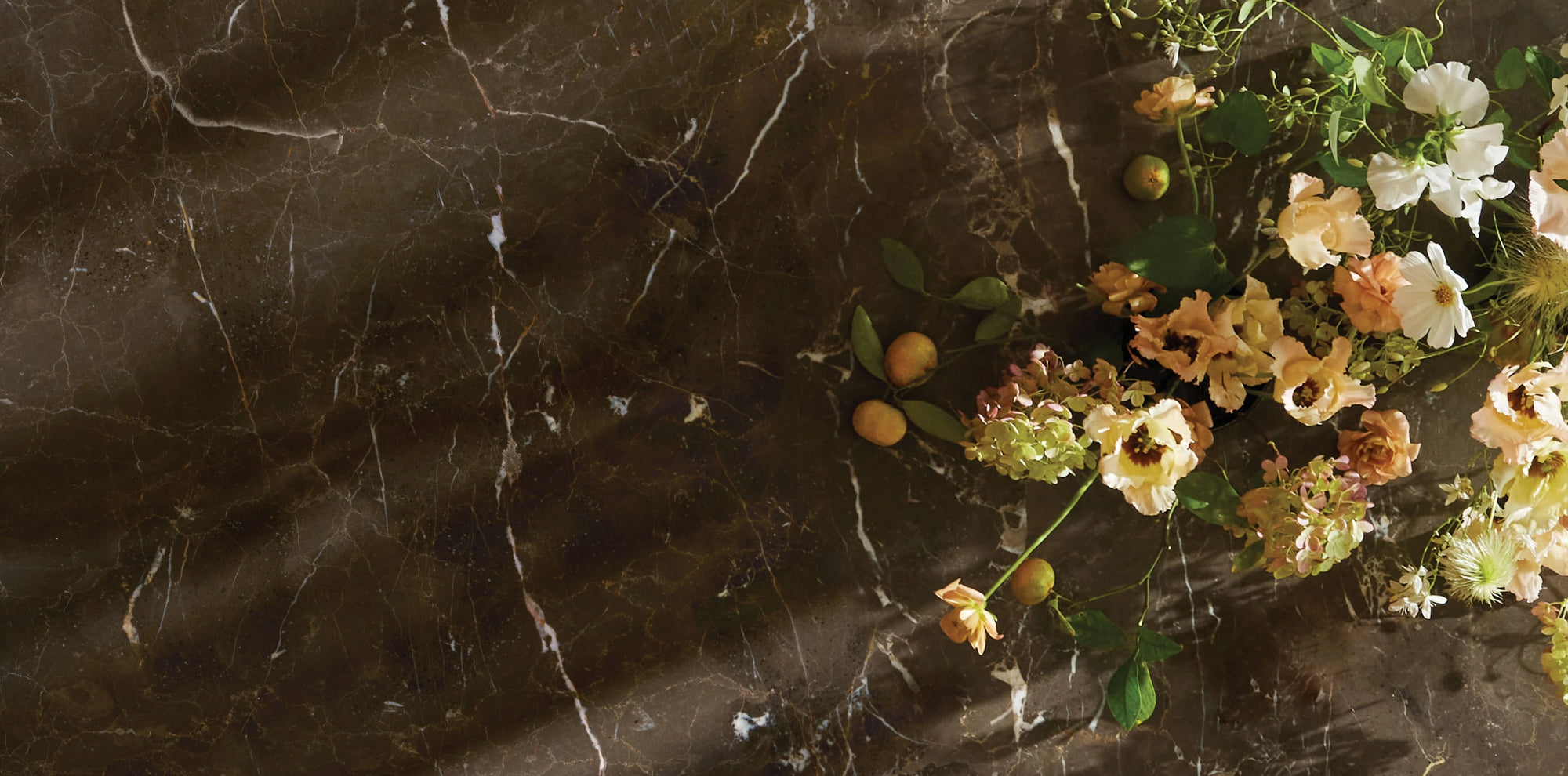 Stone texture of dining room table top with bright spring florals