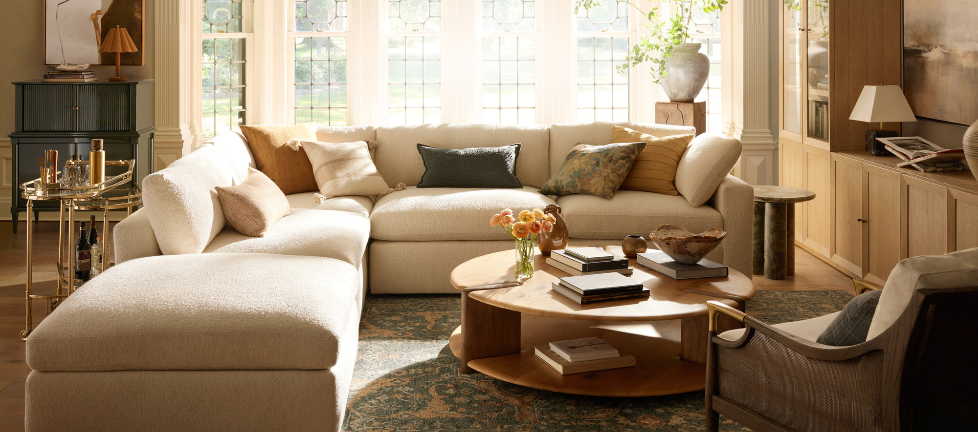 Light-filled interior with airy textures, soft neutral furnishings, and seasonal styling that evokes a fresh, summery atmosphere.