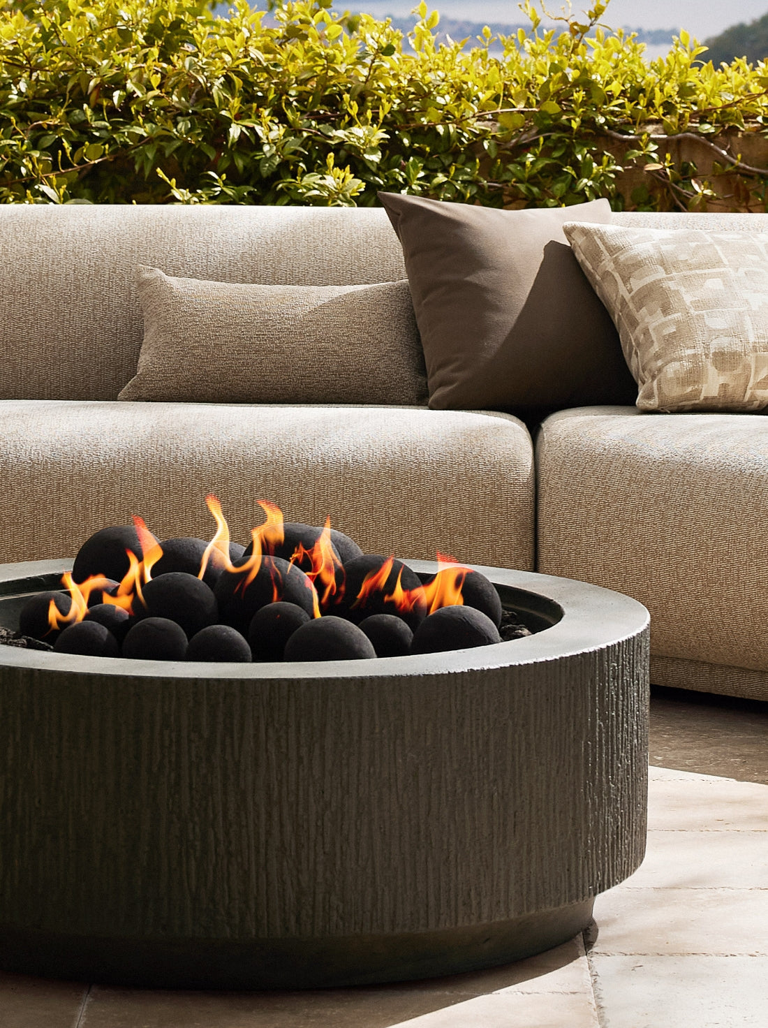 Outdoor decor with planters, vases, fire pits, and layered textures, adding warmth and personality to an open-air space.