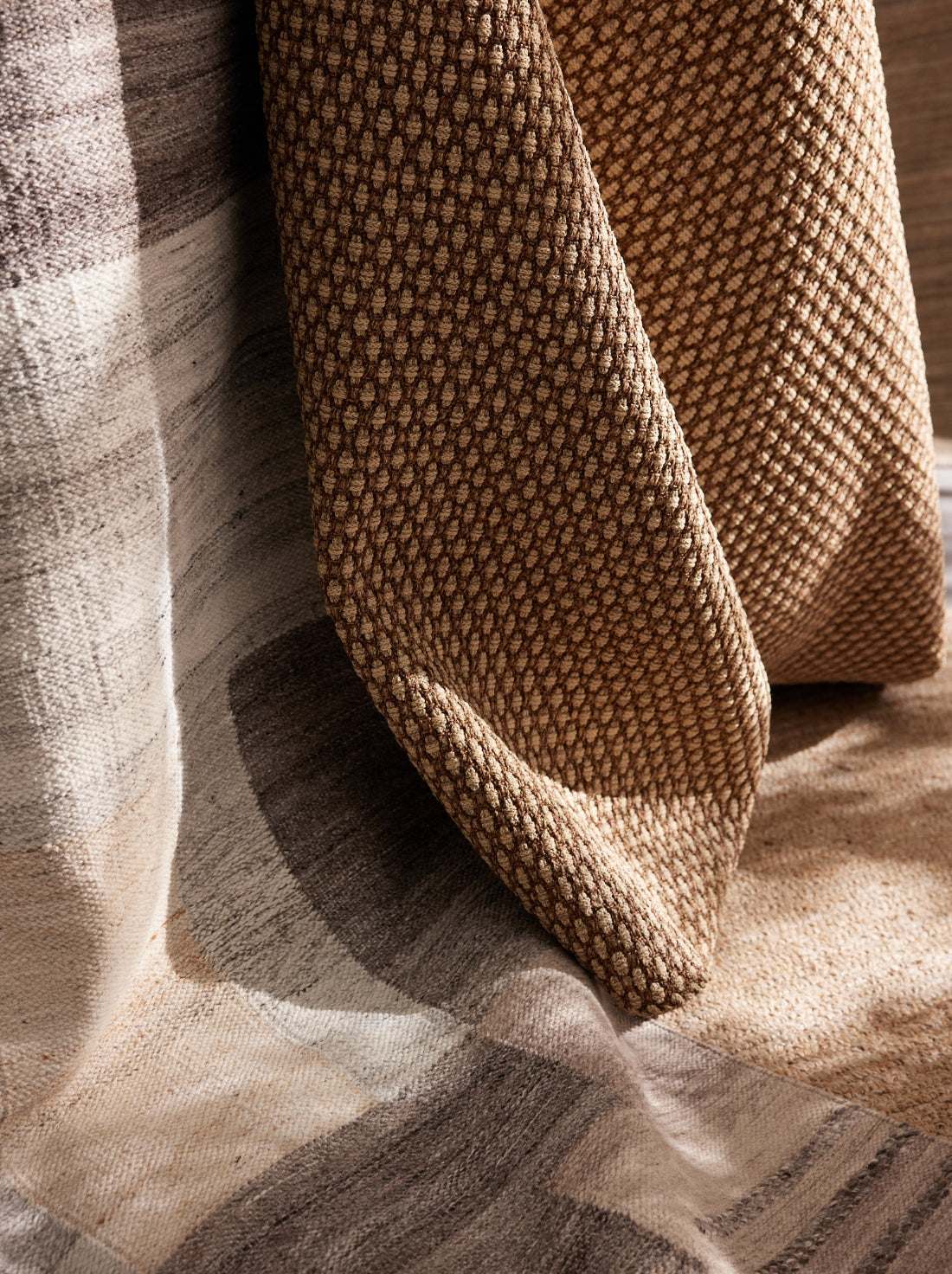 Outdoor rugs with durable textures and patterns, grounding the space and adding comfort underfoot.