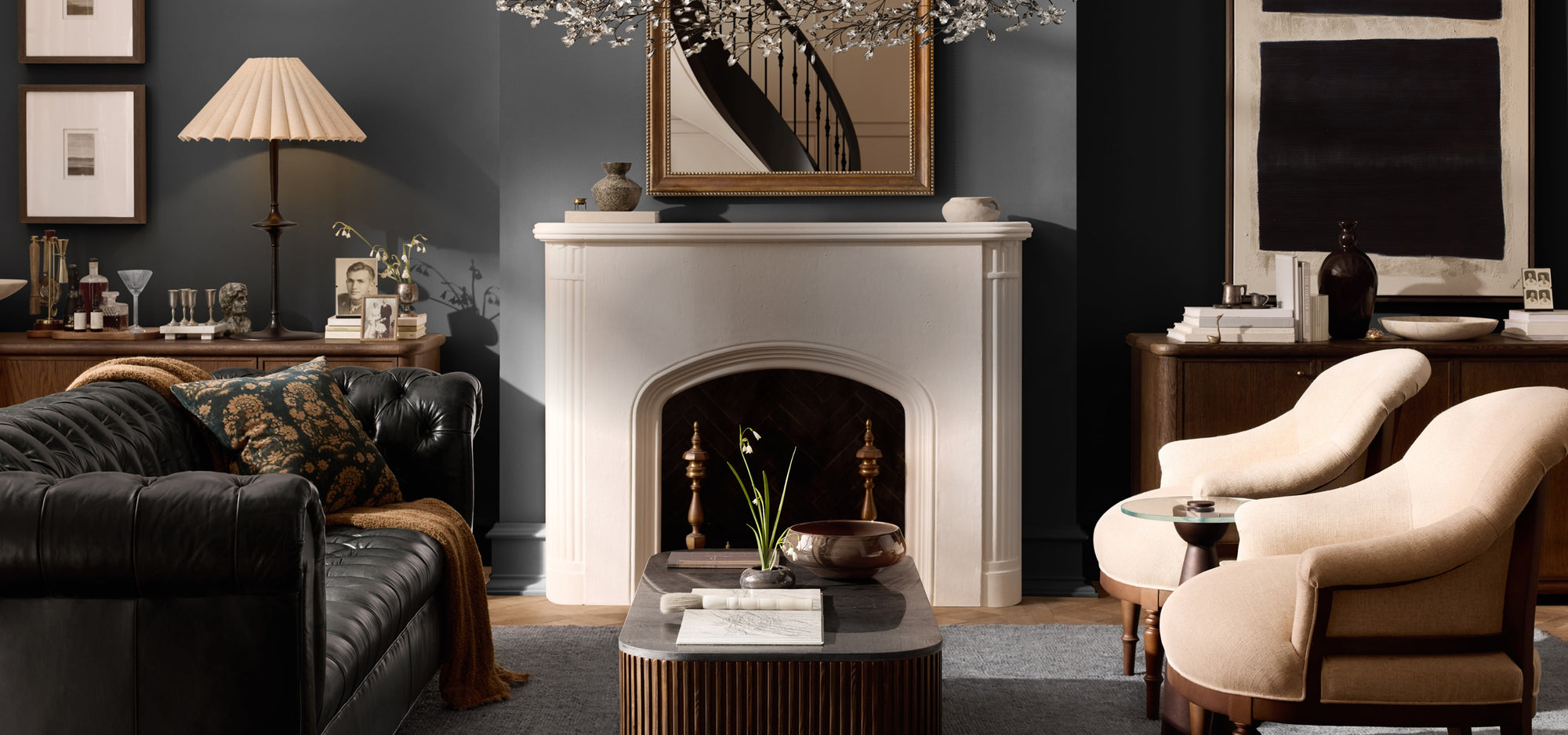 Traditional, refined living space with tufted leather upholstered seating, and warm wood furnishings, styled with layered textures and timeless decorative accents.