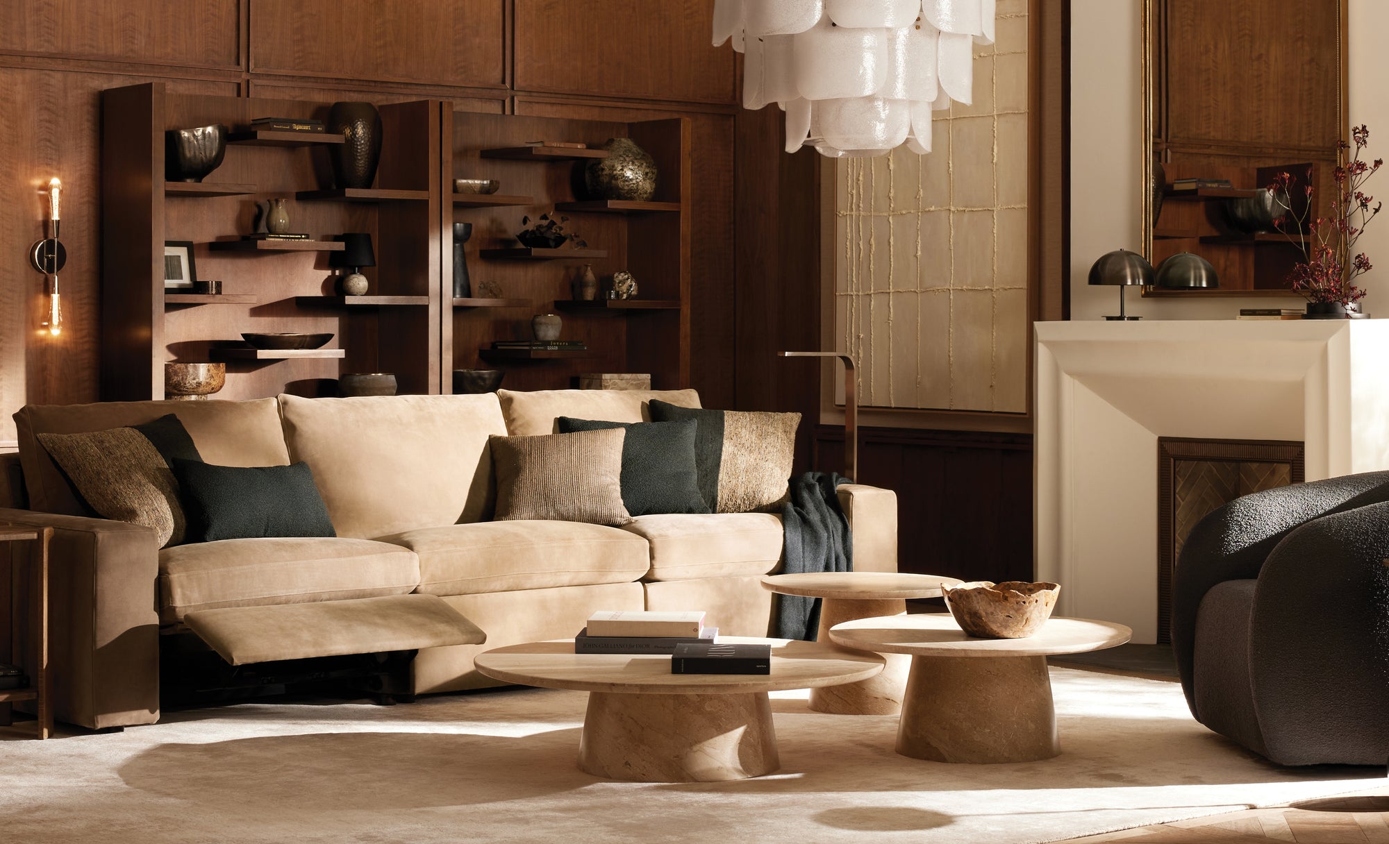 Modern living room with beige sofa, coffee table, and decorative items.