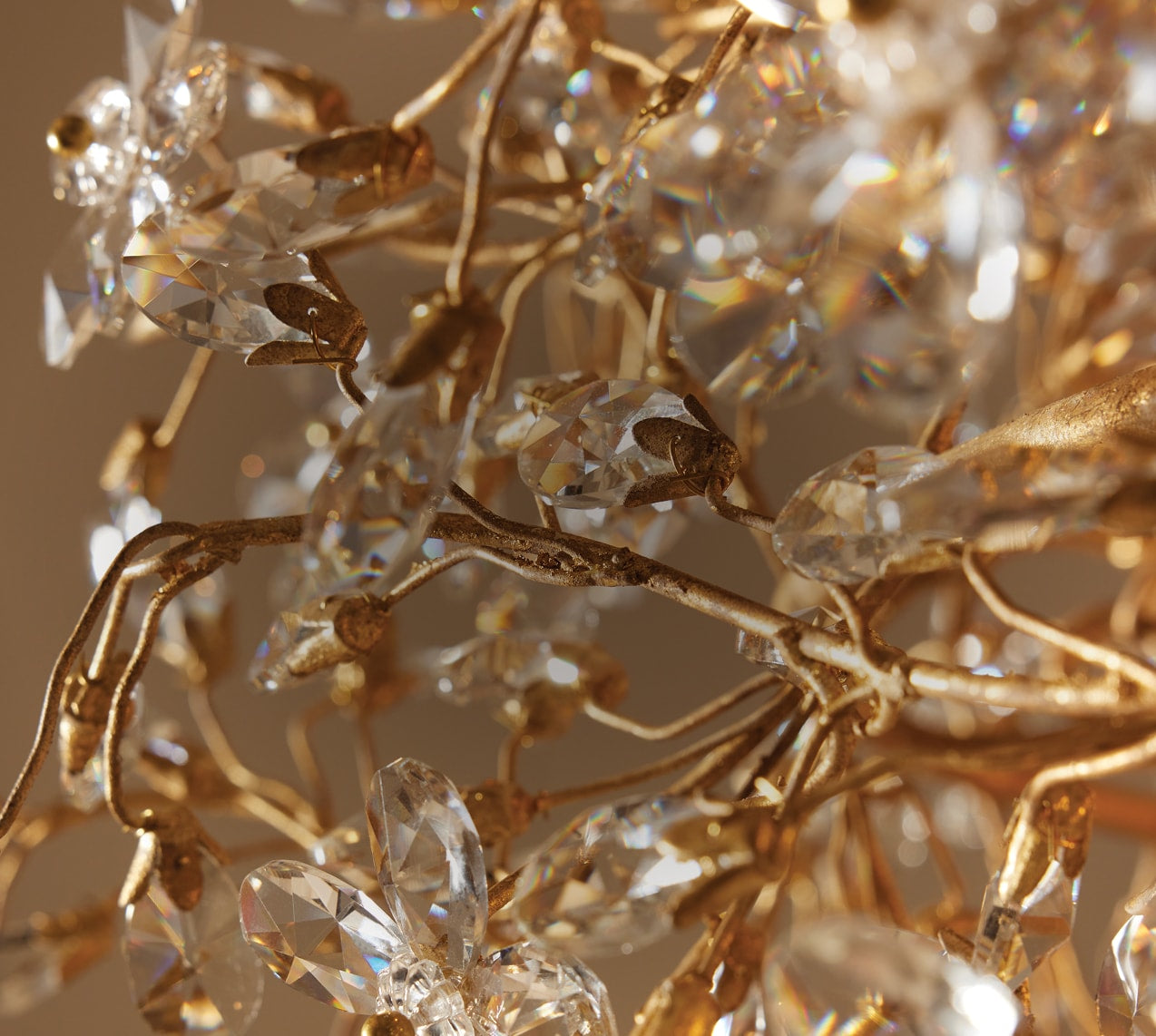 Statement lighting fixture with sculptural detailing and warm illumination, styled within a thoughtfully layered interior featuring rich textures and refined decorative accents.